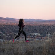 DMRWX woman running in the mountains in winter