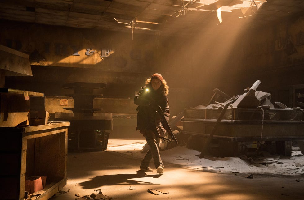 A person exploring an abandoned building with a flashlight