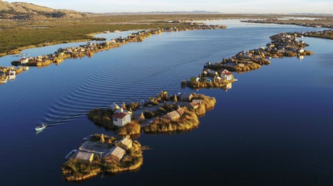 TITICACAMEER, PERU TITICACAMEER PERU De leden van het Urovolk die aan de oevers van het Titicacameer in Peru leven hebben hun dorpen in de loop van tijd op vaste grond gevestigd door hun boothuizen van riet met elkaar te verbinden en aarde van het vasteland te gebruiken om ketens van eilandjes met akkerland te creren