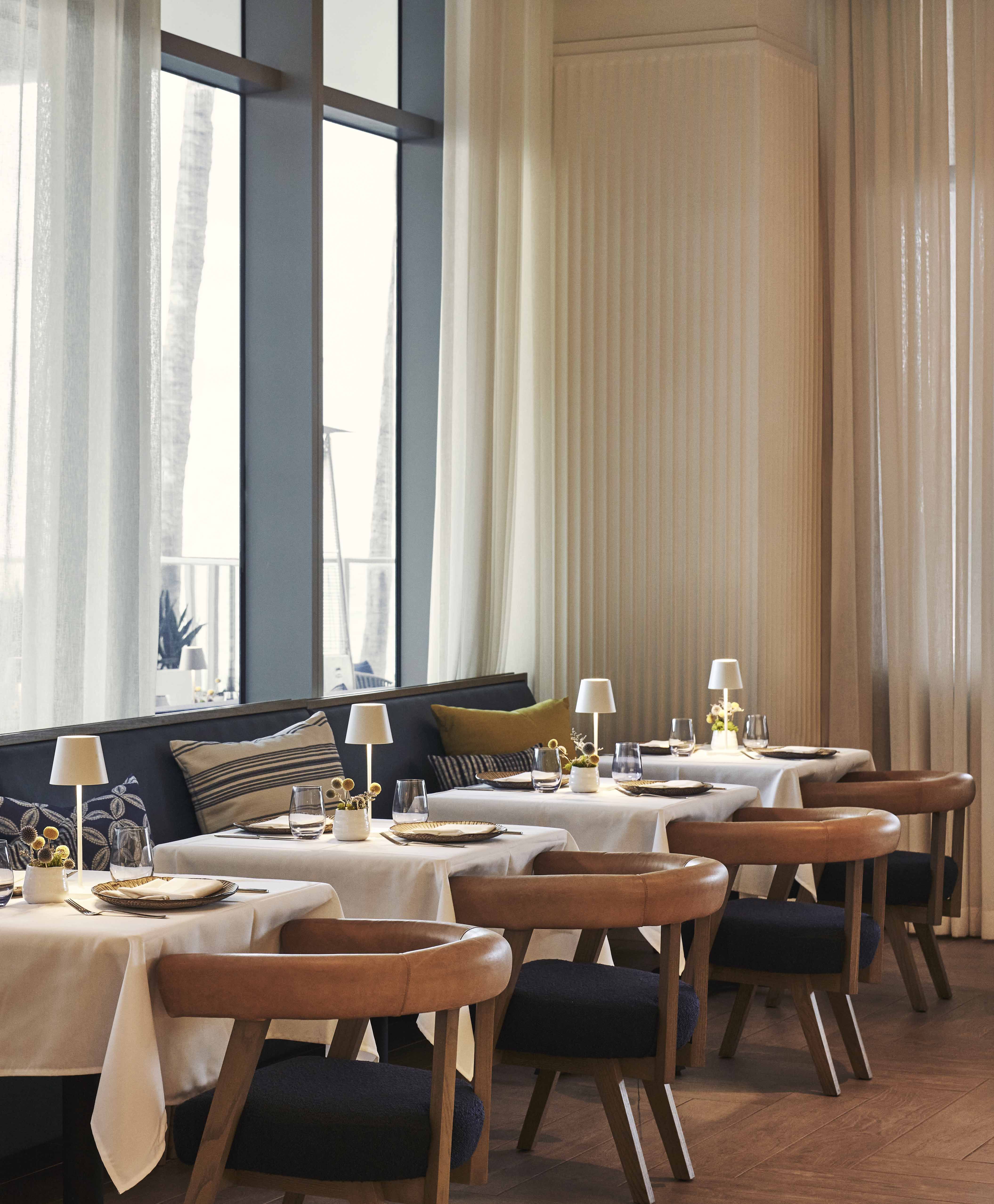 A List 2022 - ELLE DECOR restaurant interior with banquette and round back wood chairs