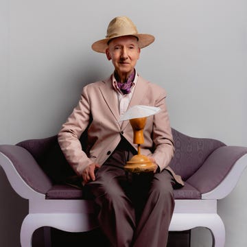 a person sitting on a couch holding a trophy