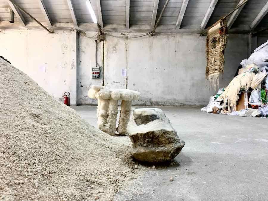 a couple of stone benches in a concrete room