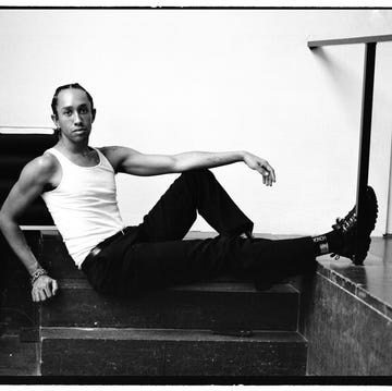 a person posed casually while sitting on steps wearing casual clothing a person posed casually while sitting on steps wearing casual clothing