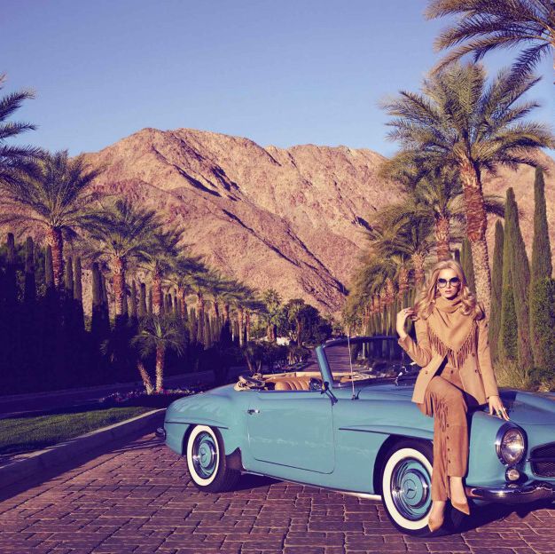 model sitting on a convertible in palm springs