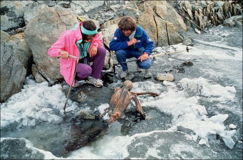Bergbeklimmer Reinhold Messner rechts en een collega bekijken de gemummificeerde resten van tzi de IJsman kort na de ontdekking van de mummie in 1991