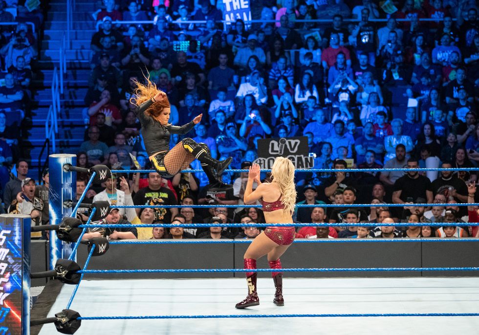 becky lynch dropkicks charlotte flair during a may 2019 edition of wwe’s smackdown live