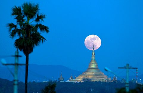 De supermaan komt op achter de Uppatasantipagode ook wel de Vredespagode genoemd gezien vanuit de Myanmarese hoofdstad Naypyidaw