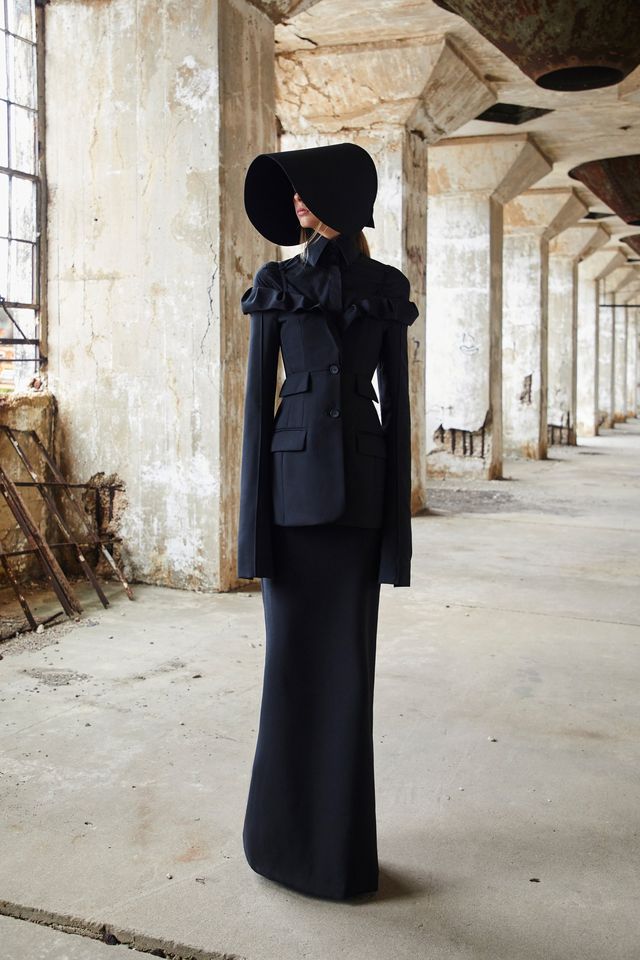 Clothing, Fashion, Outerwear, Coat, Standing, Trench coat, Street fashion, Headgear, Dress, Hat, 