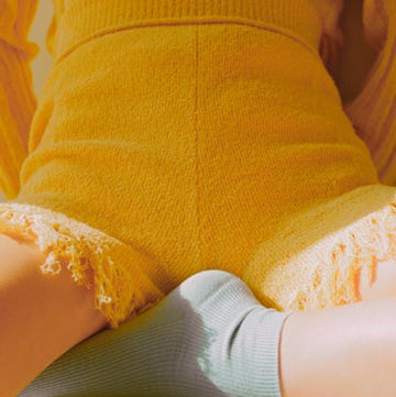 a person's arm with a yellow and blue shirt