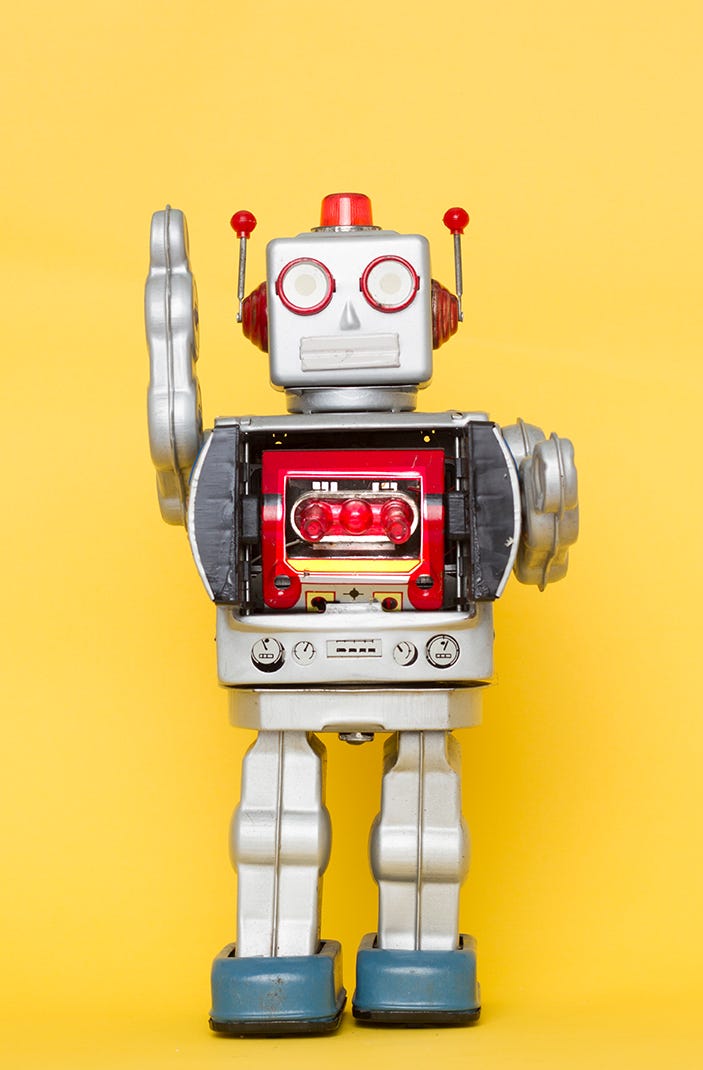 closeup of toy robot against yellow background