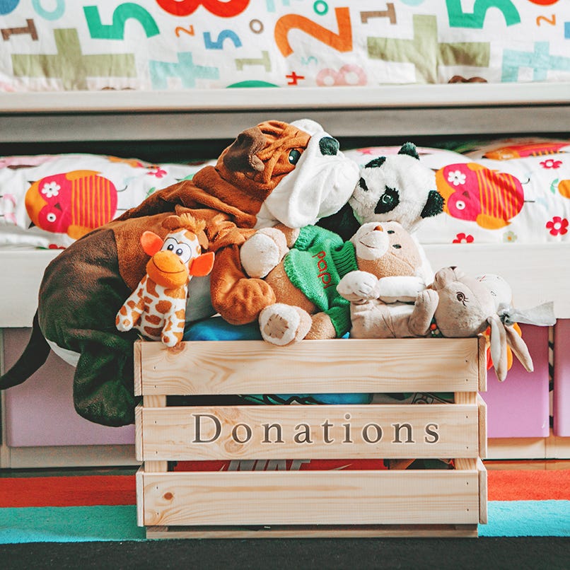 wooden donation box filled with stuffed animals