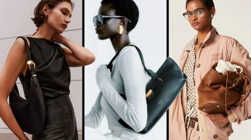 fashionable women holding designer handbags