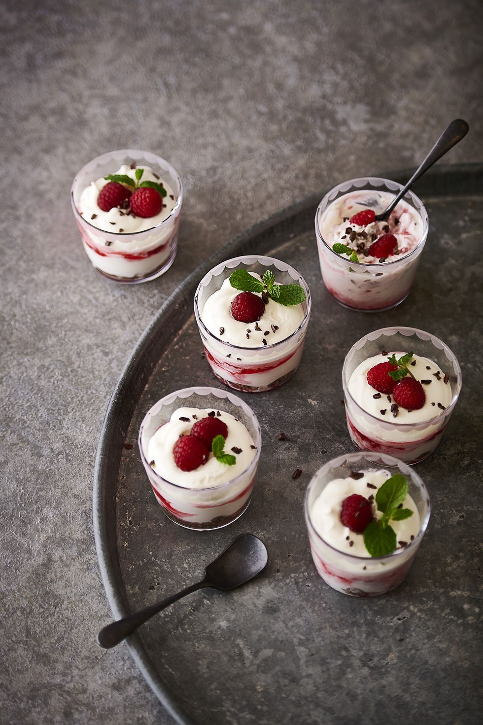 a group of desserts with strawberries and a spoon