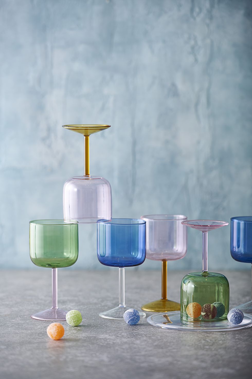 a group of glasses with colored liquid