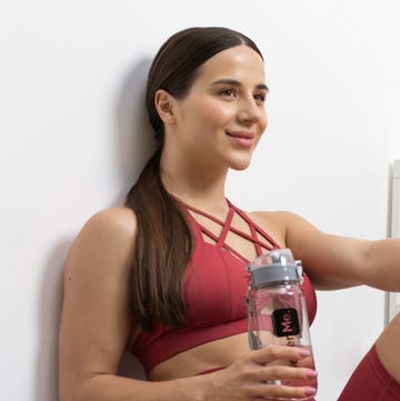 a woman holding a glass of water