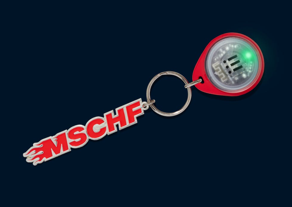 keychain featuring a logo and a led light