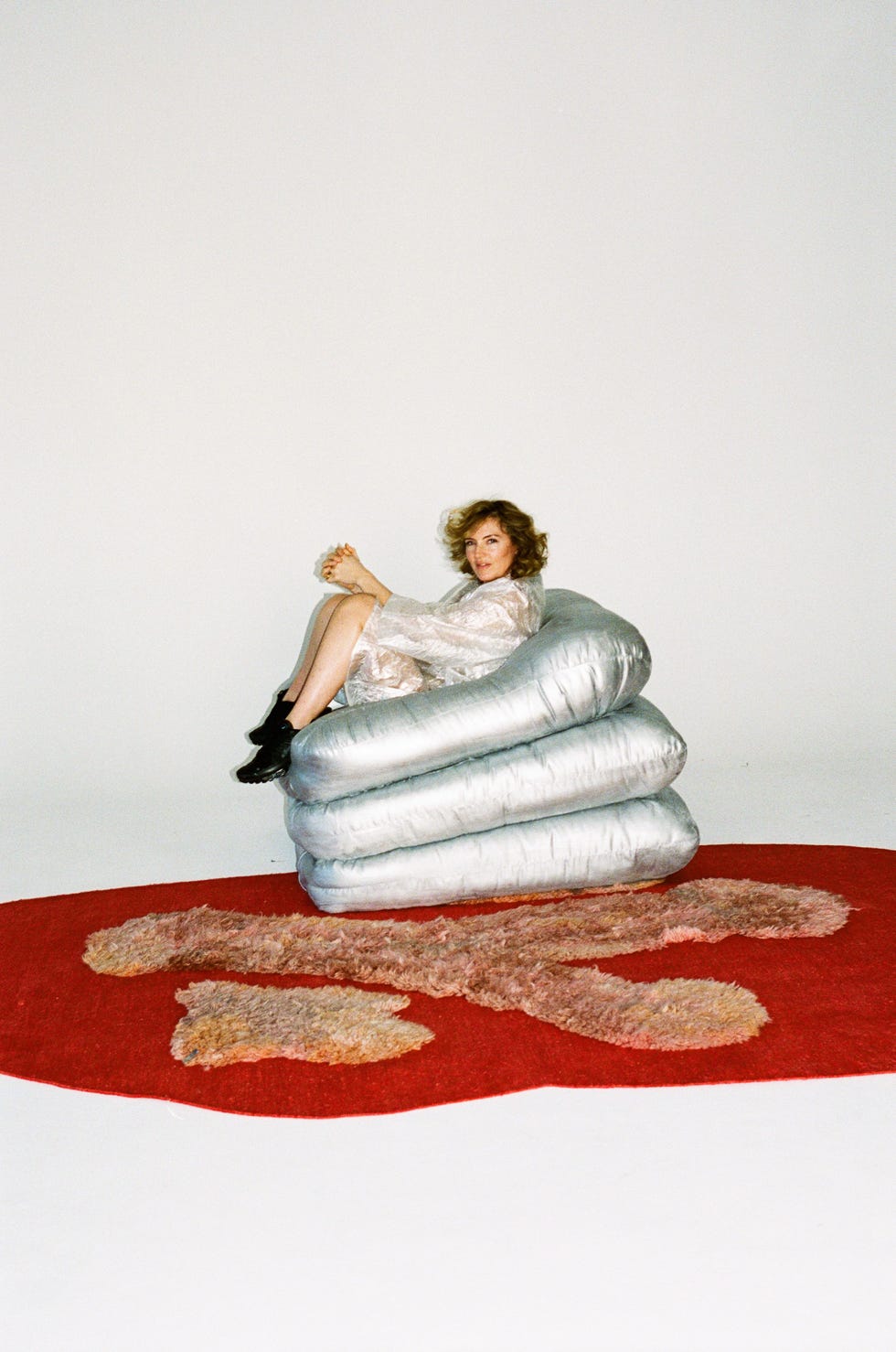 a person sitting on a pillow armchair
