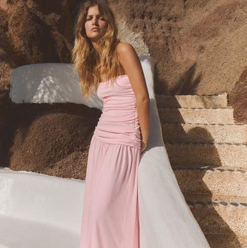 portrait of a woman in a pink dress against a textured background portrait of a woman in a pink dress against a textured background