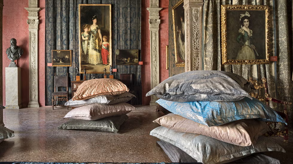 Artistic interior with decorative pillows and classical artworks.