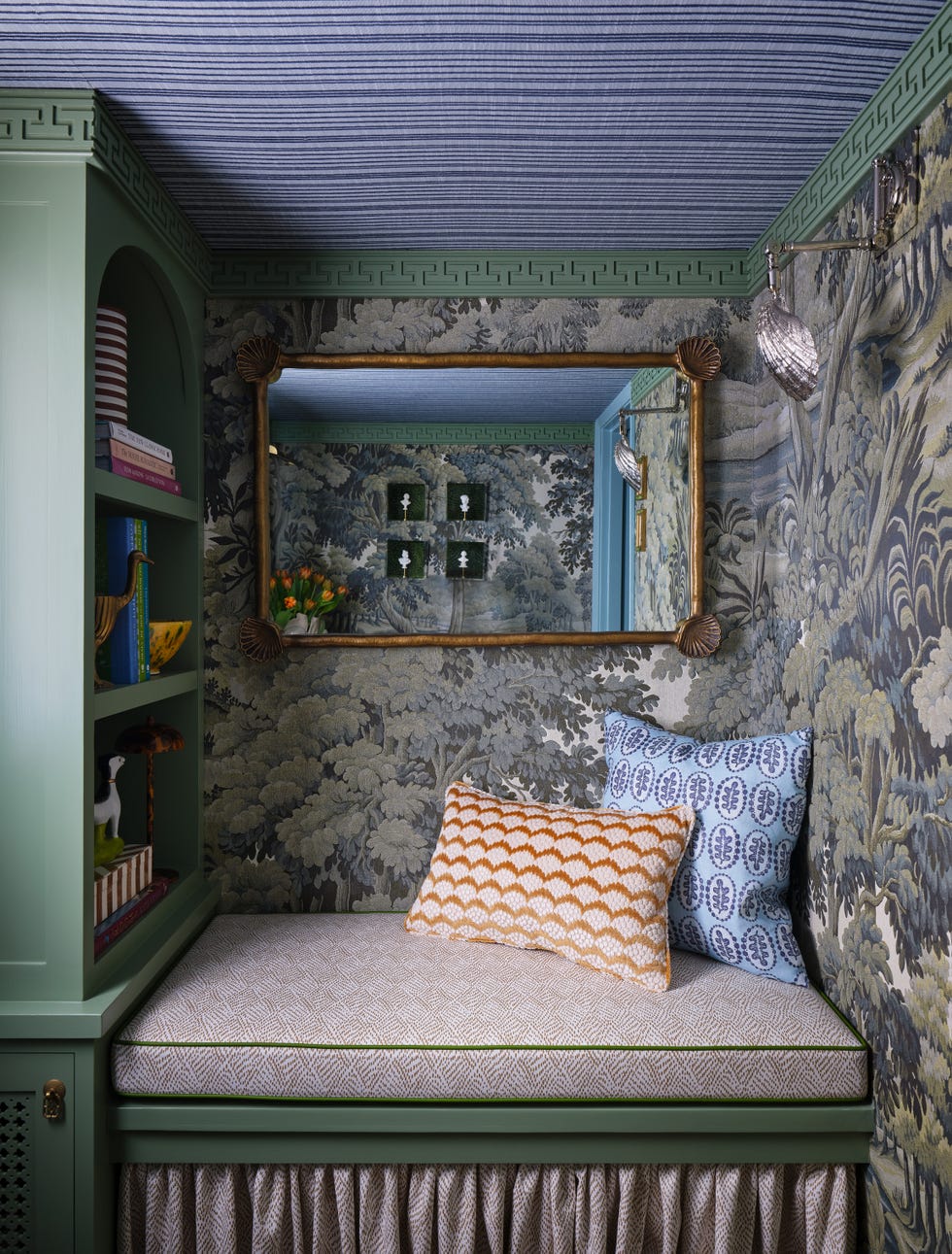 green reading nook with tree mural wallpaper