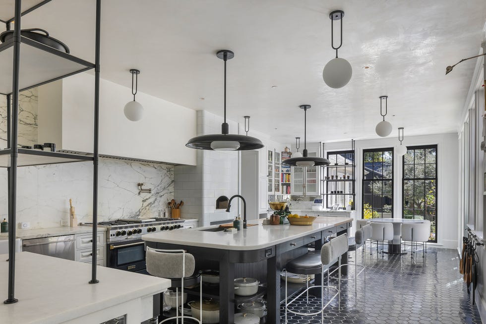 a kitchen with a large table and chairs