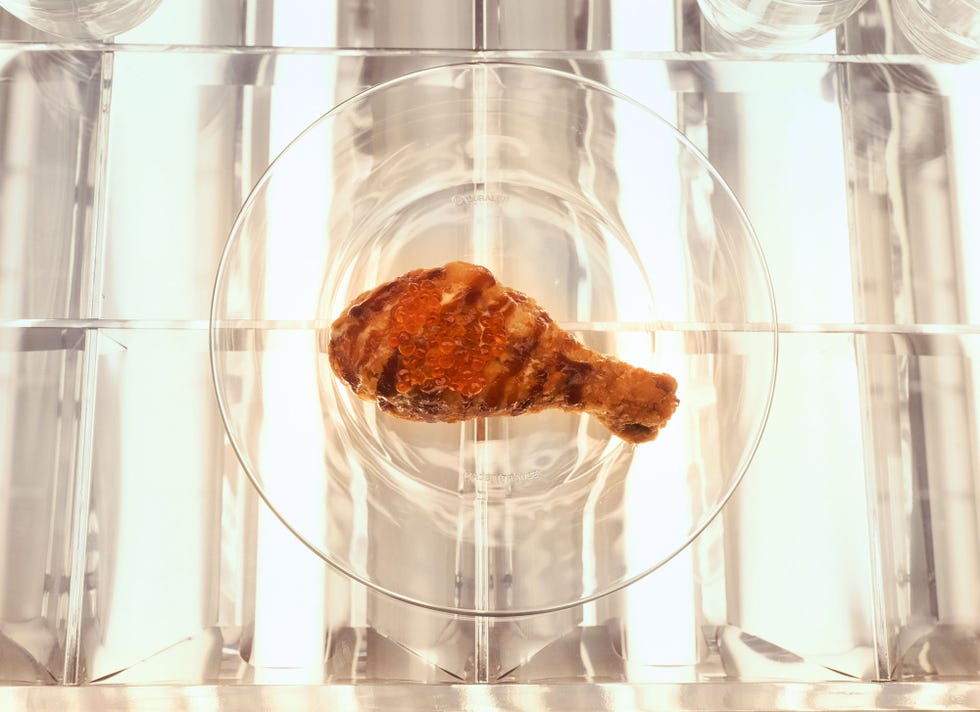 Fried chicken drumstick on a clear plate.