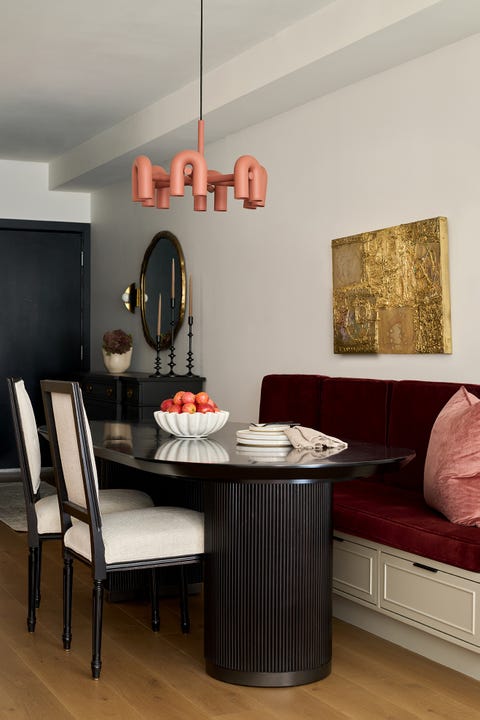 dining area with a table, a booth and chairs, and a bowl of fruit on the table