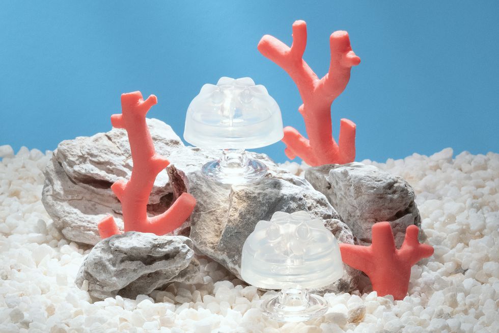 a group of red plastic toys on a white surface