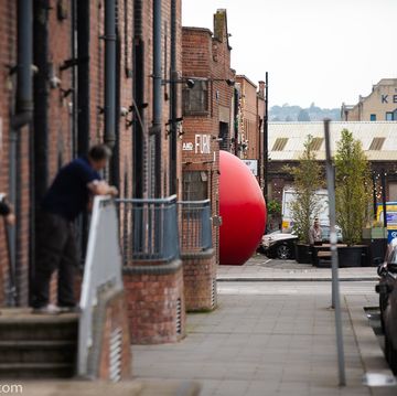 a red balloon tied to a building