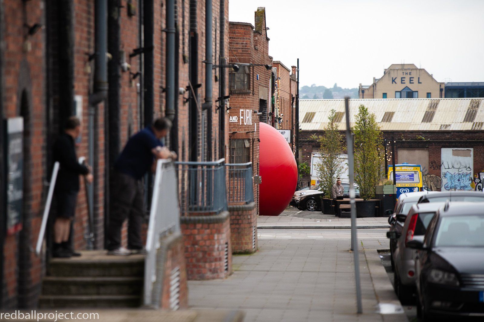 a red balloon tied to a building