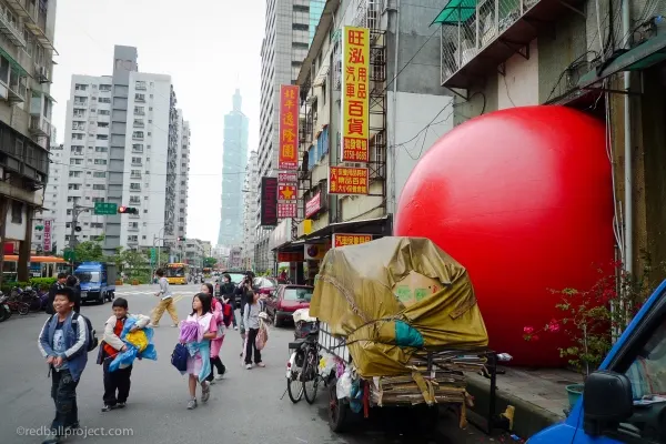 a large red balloon on a street