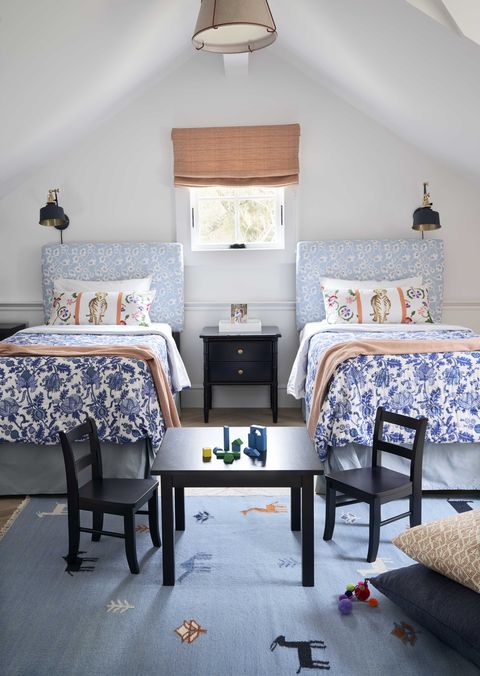kids bedrroom, twin beds, black chairs and table with building blocks, floral headboard