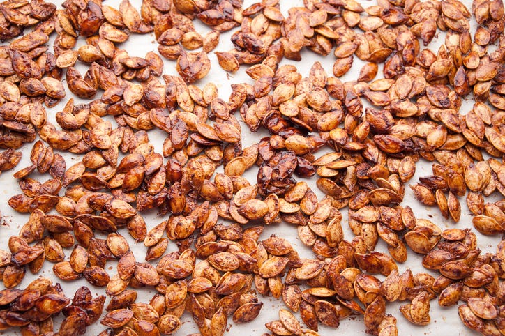 a baking sheet topped with brown sugar roasted pumpkin seeds recipe, a healthy sweet snack
