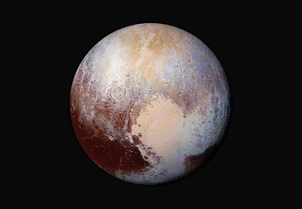 Deze met kleur verbeterde foto onthult Plutos verrassend pokdalige oppervlak afgewisseld door veel donkerder en zeer heldere gebieden