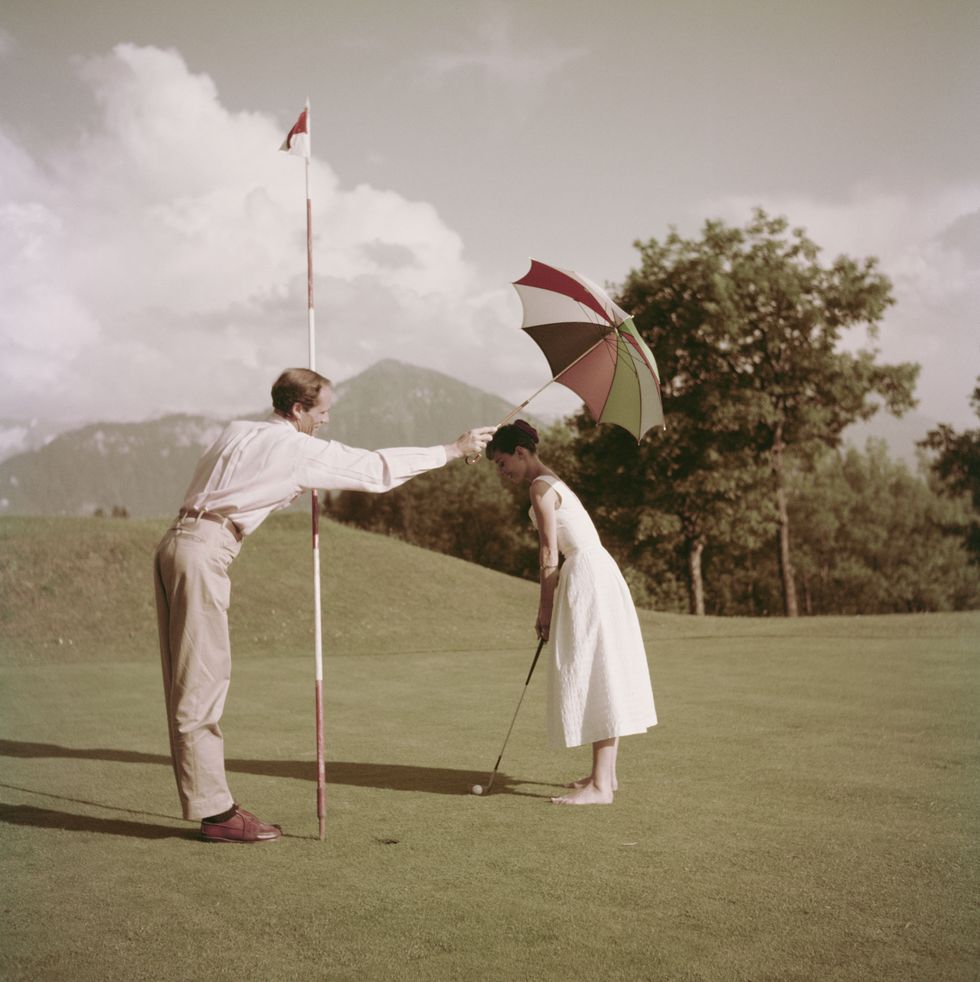 Hepburn And Ferrer Play Golf