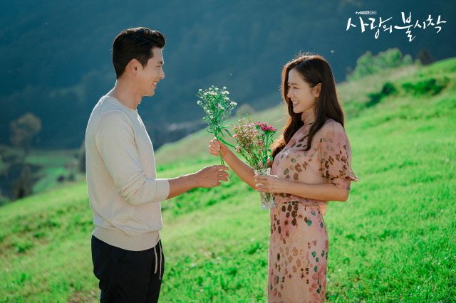 a man and woman holding flowers