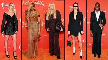 five individuals in fashionable outfits posing on a red carpet