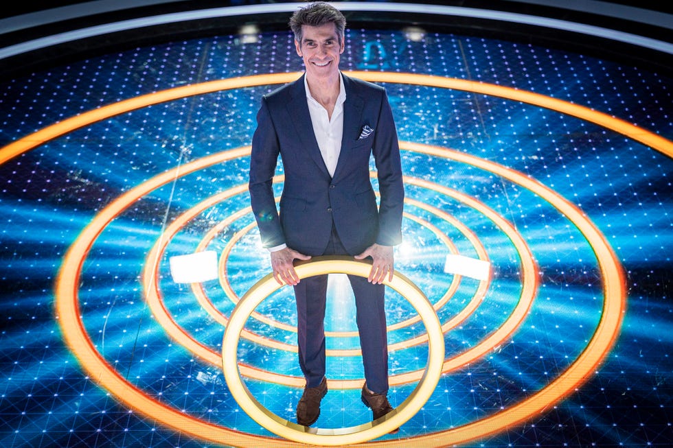 Electric blue, Formal wear, Majorelle blue, Blazer, Space, World, Cobalt blue, Flash photography, Astronomical object, Television presenter, 