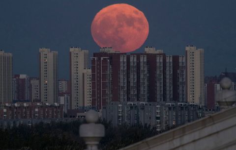 A supermoon rises behind apartment buildings in Beijing China in November 2016