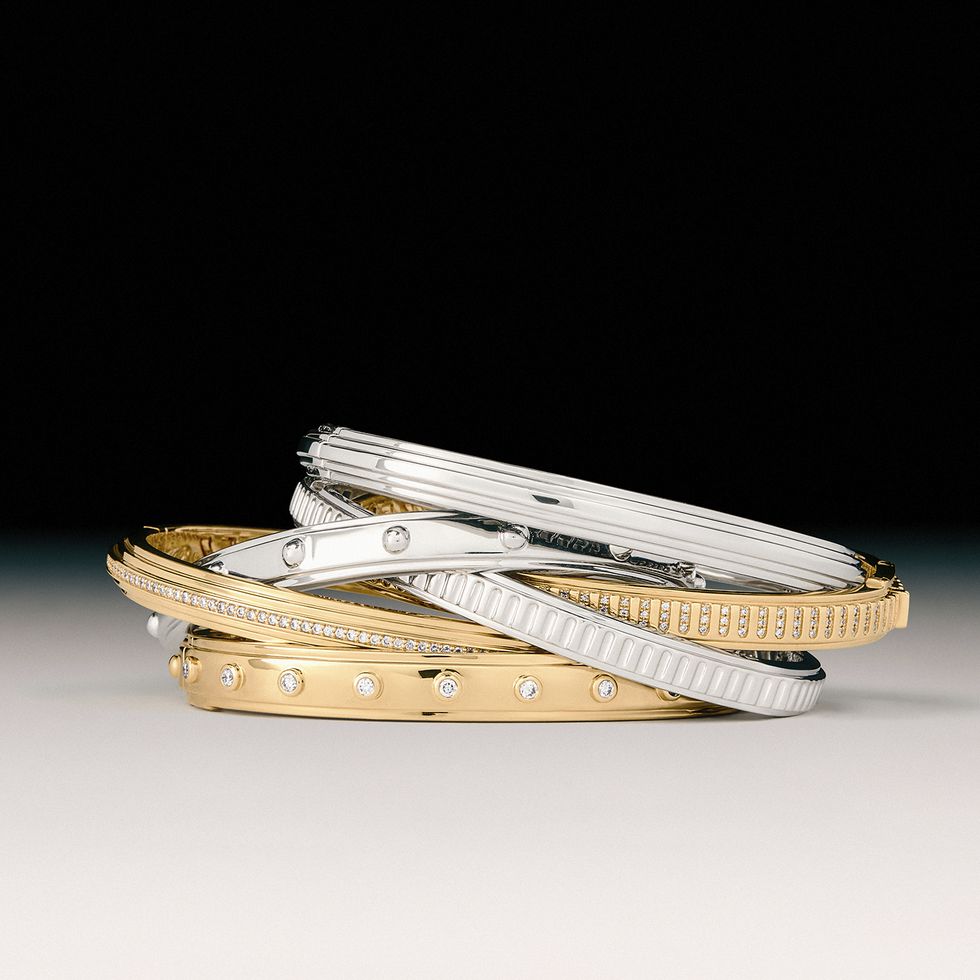 a pair of gold and silver bracelets