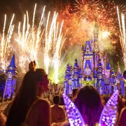 a view of the nighttime fireworks behind cinderella castle at magic kingdom park