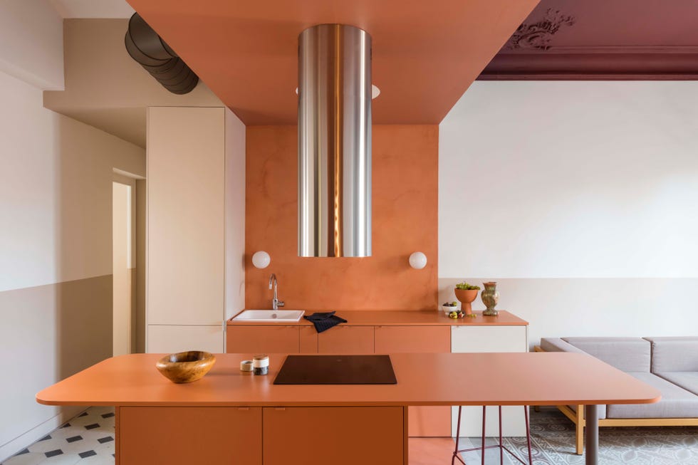 minimalist open plan kitchen painted terracotta