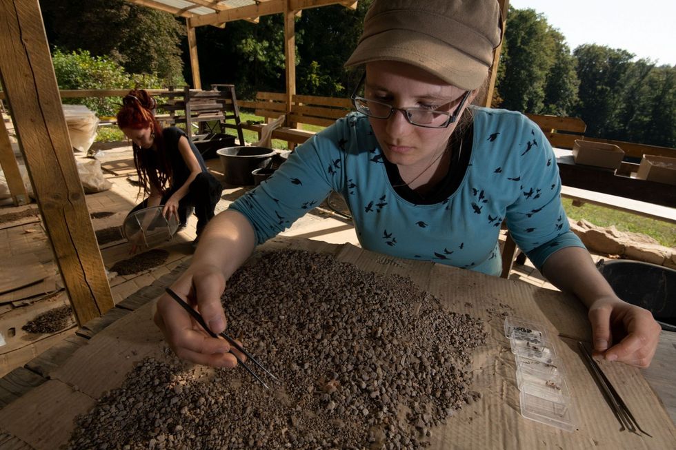 Archeologiestudenten Denise Siemens links en Runa Bohle rechts zeven en onderzoeken zorgvuldig de sedimenten die in en rond de Einhornhhle zijn opgegraven Zelfs de kleinste dierenbotten of plantenresten kunnen belangrijk zijn om te reconstrueren hoe het leven er vijftigduizend jaar geleden uitzag