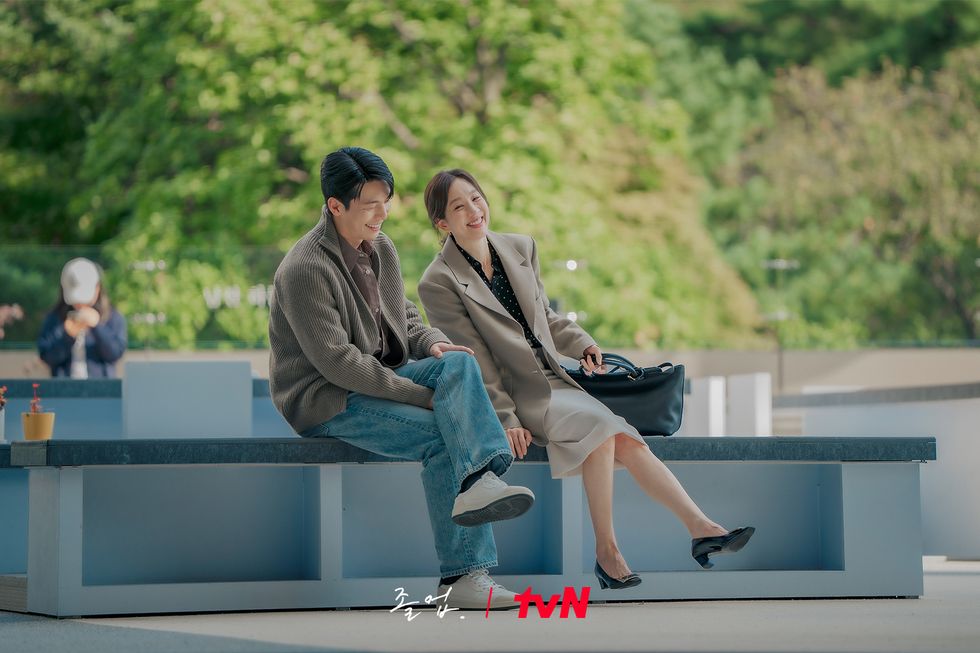 a man and woman sitting on a bench