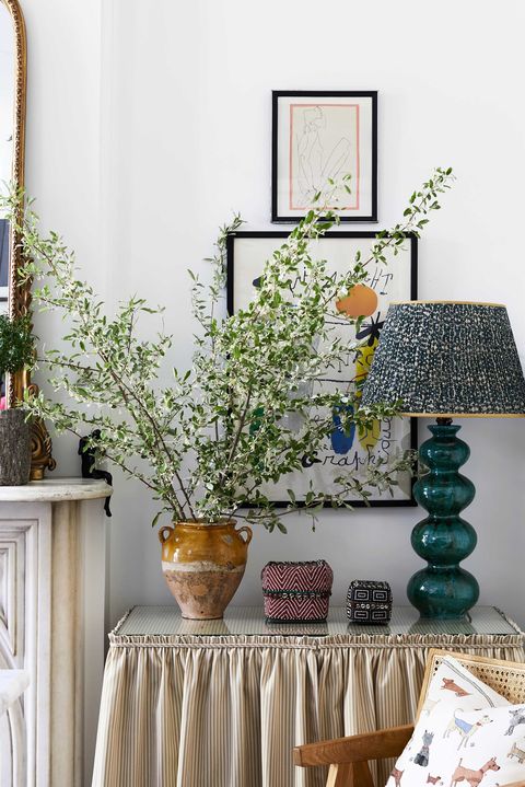 side table, green lamp, brown vase, wall art