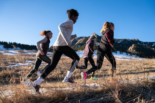 group of runners training outdoors in a natural landscape