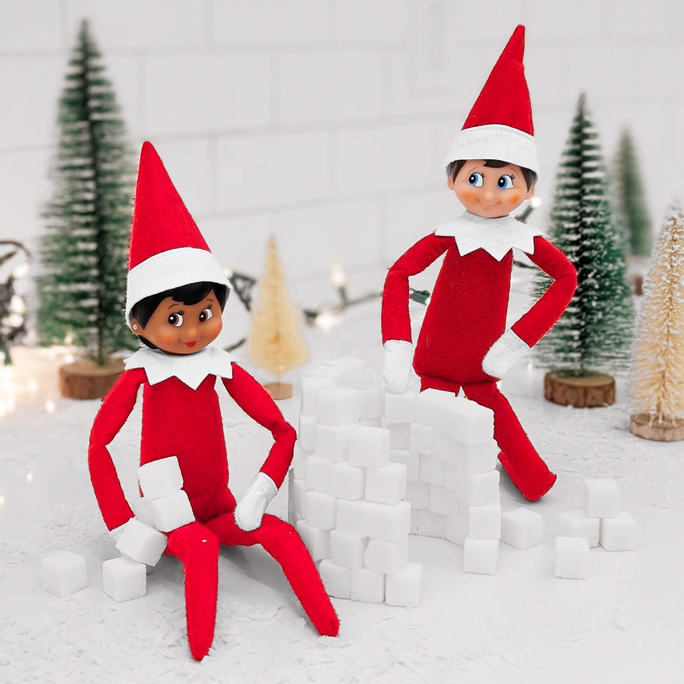 two elves build a snow fort out of sugar cubes