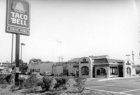 with a spanish style roof and stucco siding, this taco bell restaurant seen in 1994 was the authentic foundation of the brand millions love today