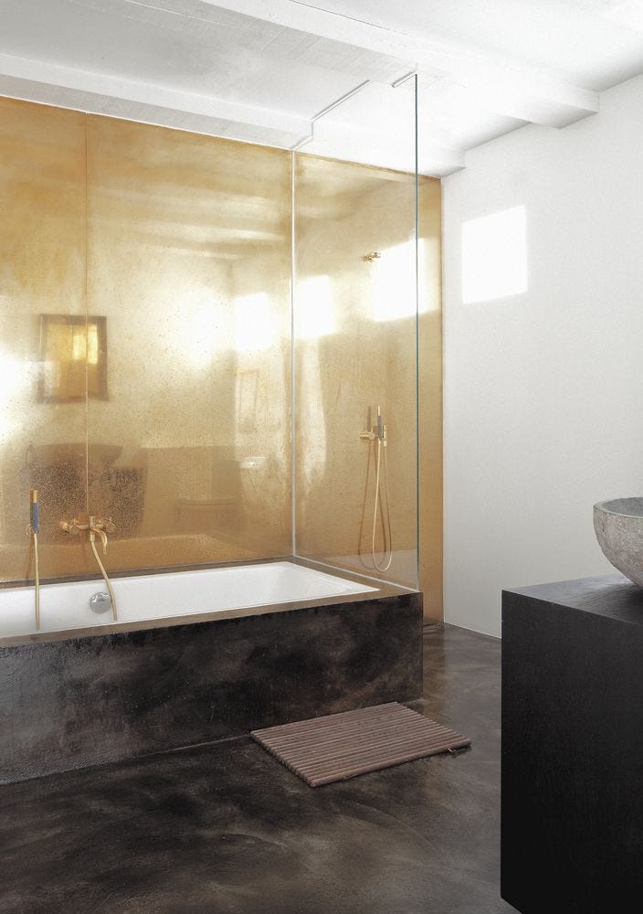 bathroom with antique metal wall and black concrete floor