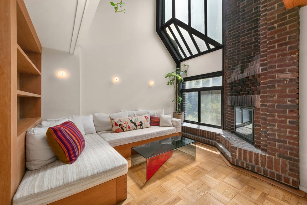 Cozy living room with a modern design featuring a sectional sofa and a fireplace.